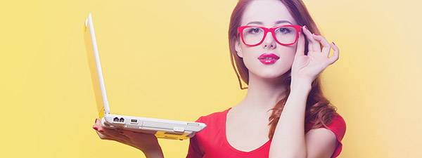Smart person with red glasses and computer, eye care near you